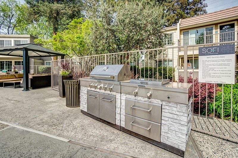a stainless steel barbecue grill in front of a house
