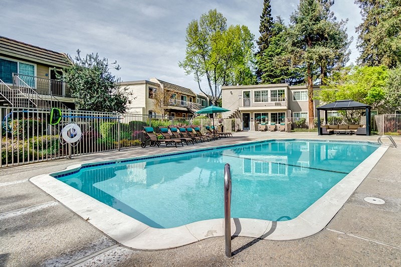 our apartments have a resort style pool with chairs and a gazebo
