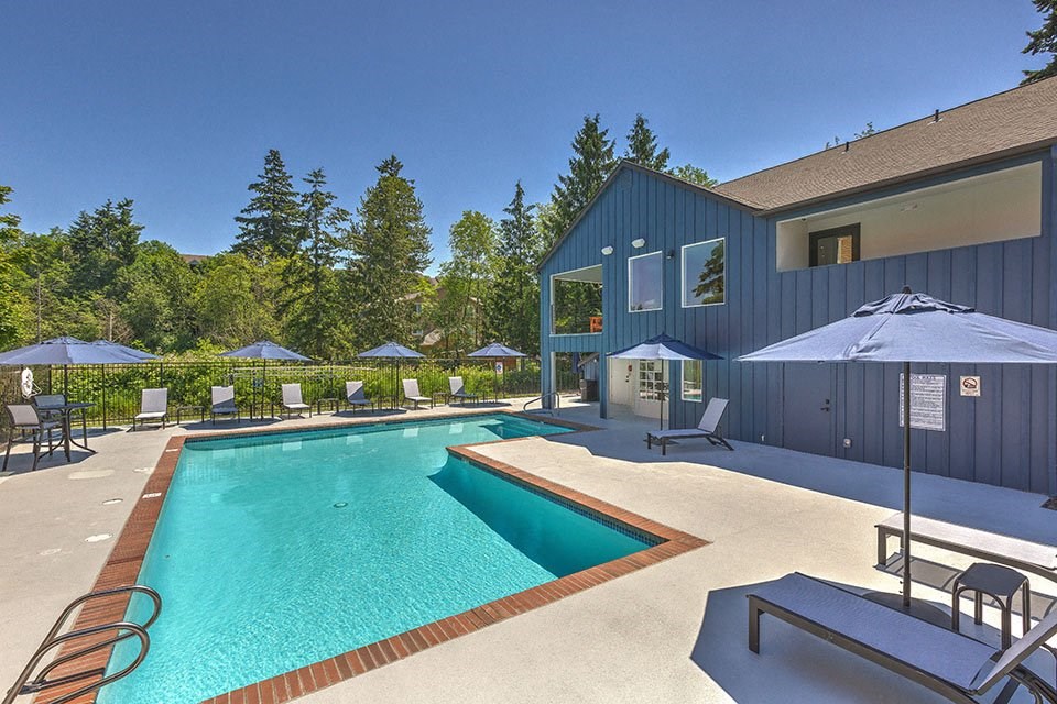 Pool with lounge chairs l Sofi Lakeside Apartments For Rent in Everett WA