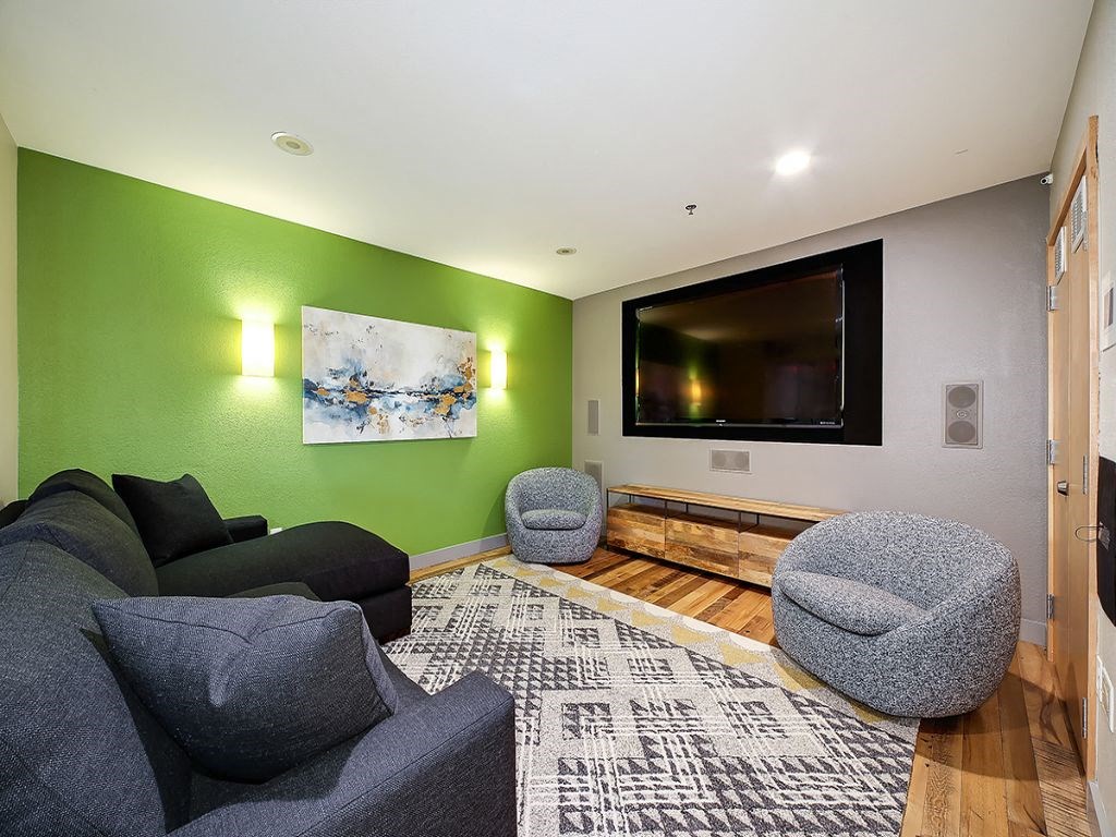 a living room with a couch and chairs and a television