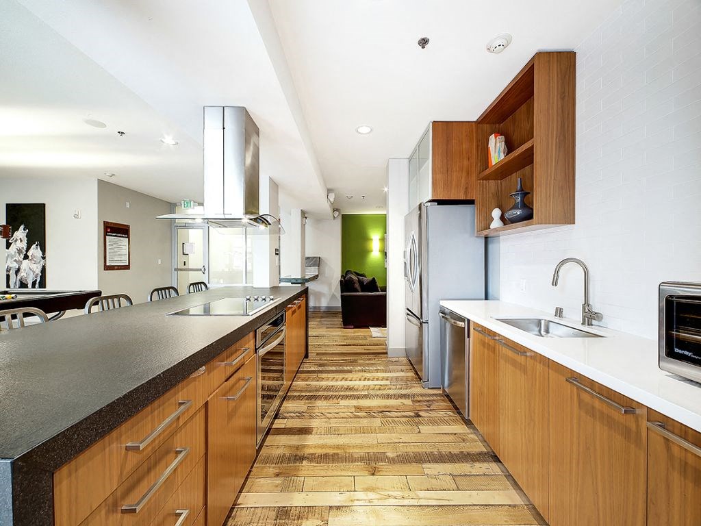 a kitchen with a long counter top and a sink