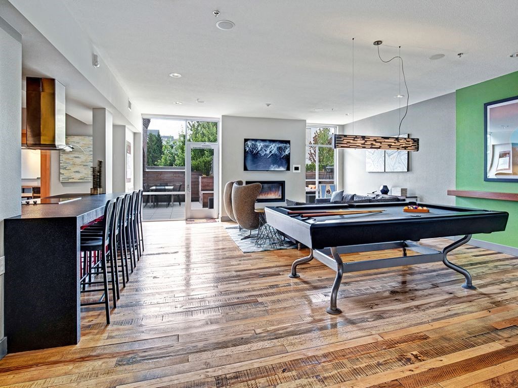 a game room with a pool table and a bar