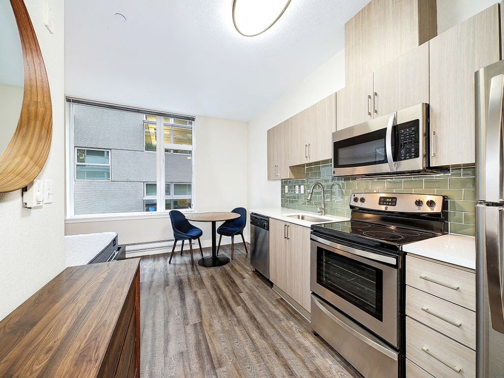 a kitchen with stainless steel appliances and a window