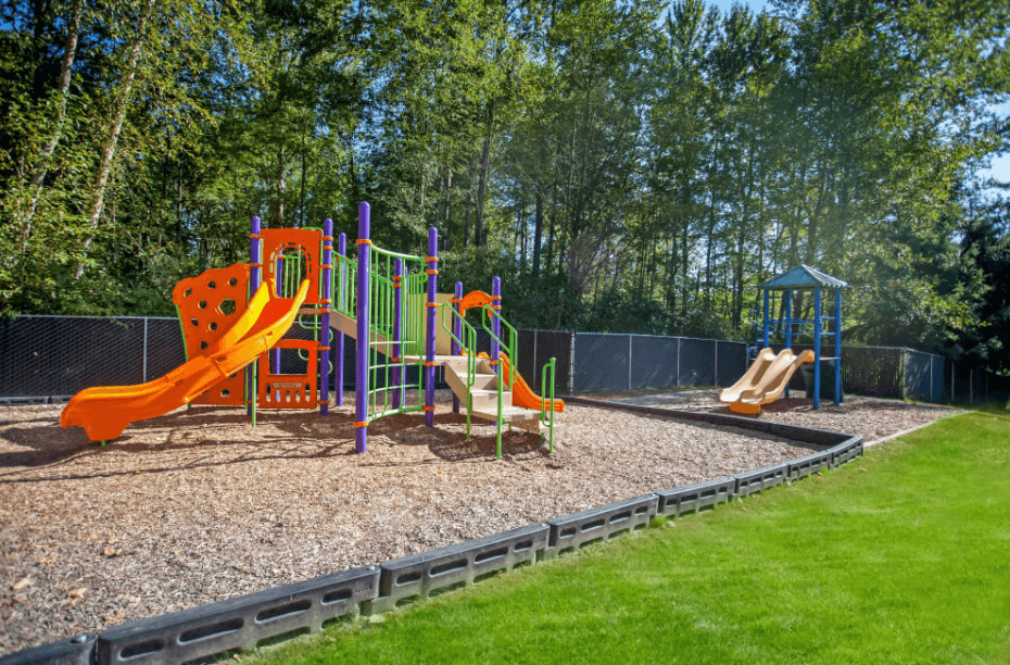 a playground with slides and other toys in a park