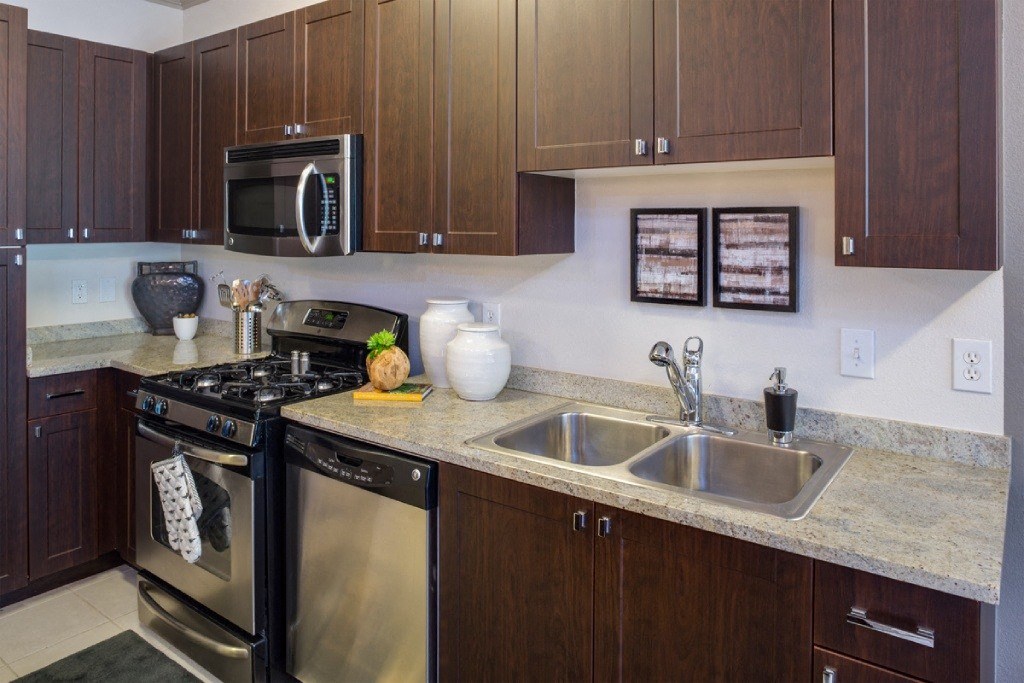 a kitchen with stainless steel appliances and granite counter tops