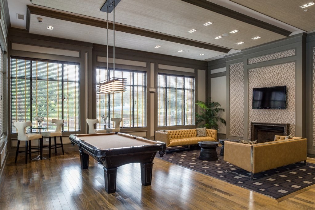 a game room with a pool table and a tv
