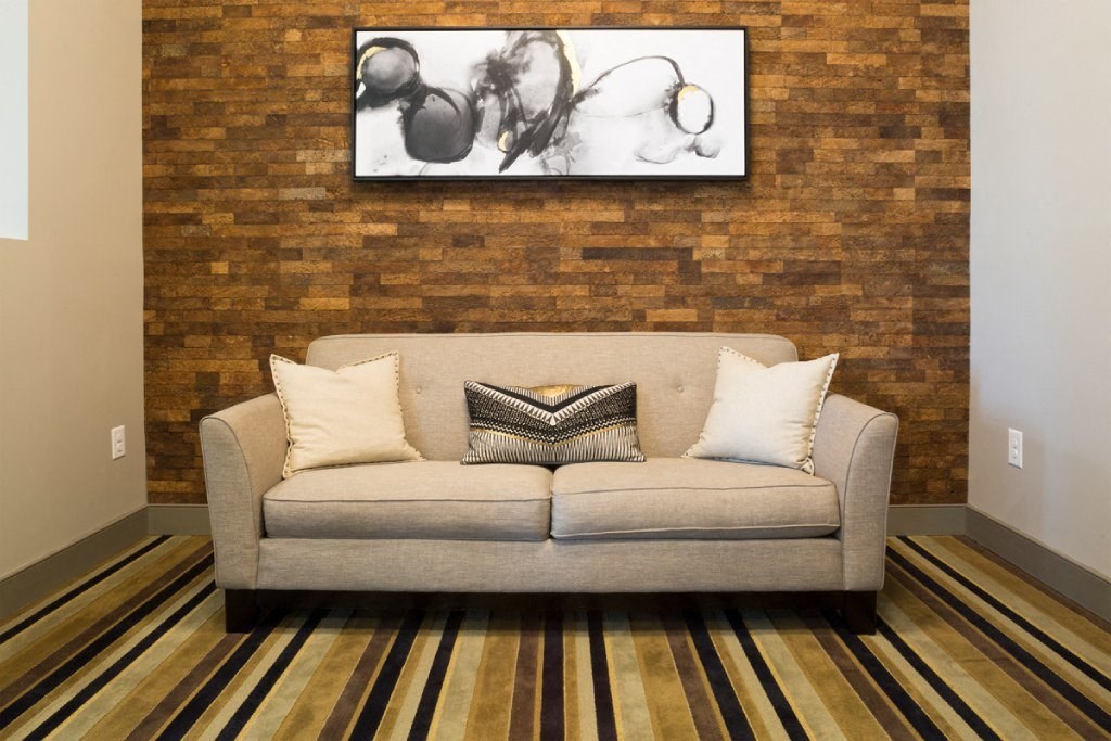 a living room with a couch and a painting on the wall