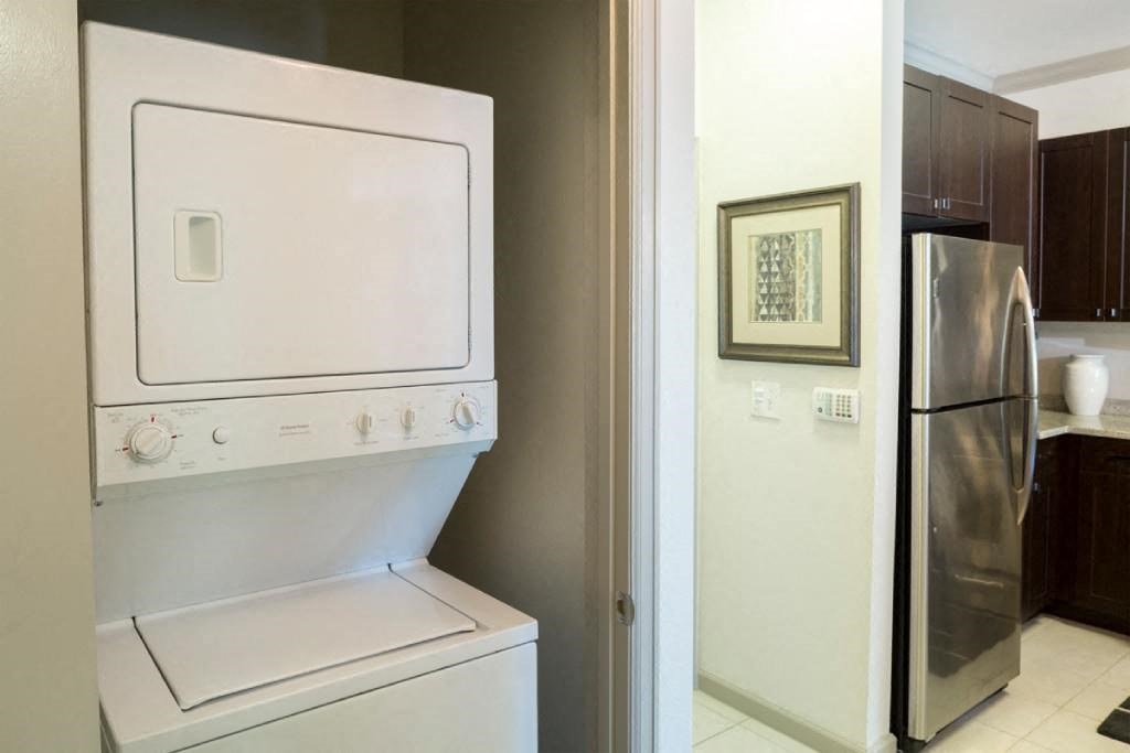 a washer and dryer in a kitchen with a refrigerator