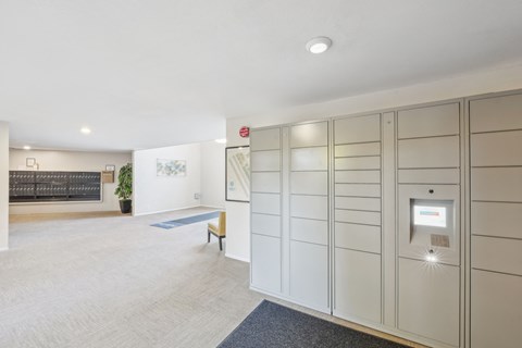 a walk in closet with white cabinets and a bench in a room with a rug