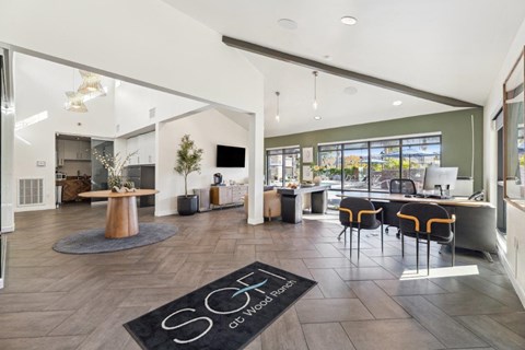 A modern office space with a reception desk and chairs.