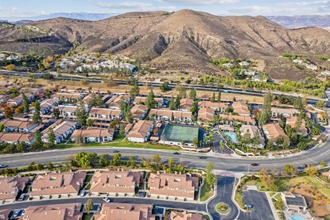 A suburban neighborhood with houses and a mountain in the background.