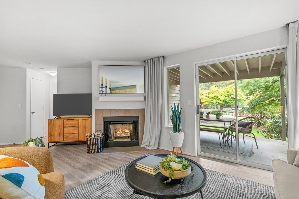 a living room with a fireplace and sliding glass doors leading to a patio