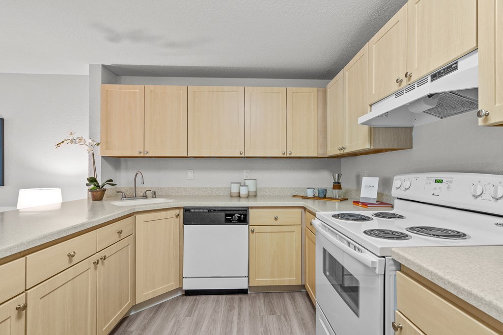a kitchen with wooden cabinets and white appliances