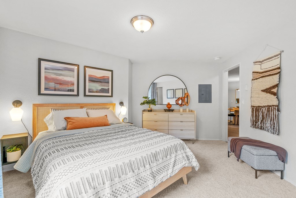 a bedroom with a bed and a dresser