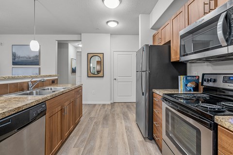 a kitchen with stainless steel appliances and wooden cabinets