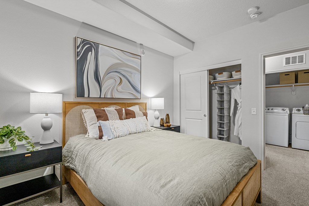 a bedroom with a large bed and a closet