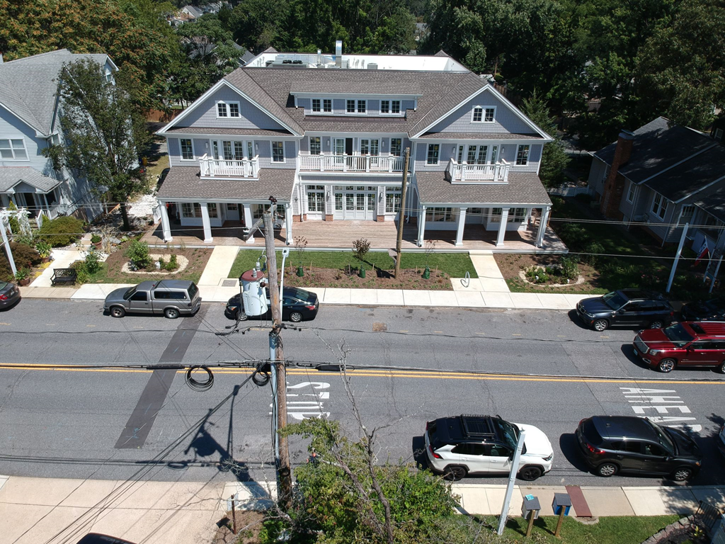 an aerial view of a large house on a city street