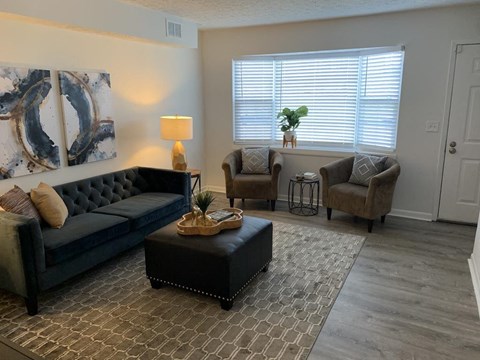 a living room with a couch and two chairs