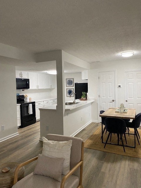 A kitchen with a dining table and chairs.