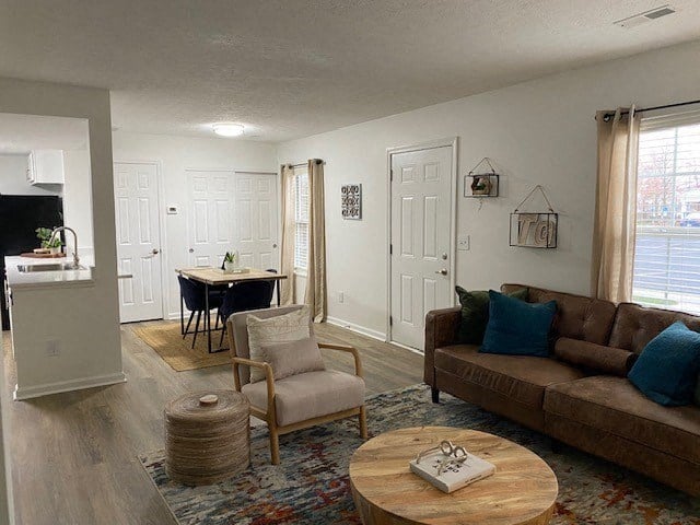 A living room with a brown couch and a wooden coffee table.