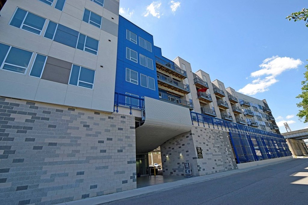 a large blue building with a street in front of it