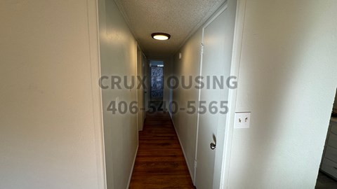 A hallway with a number and a company name on the wall.