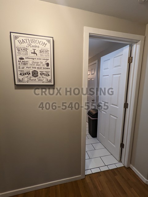 Bathroom rules sign on a wall in a hallway.