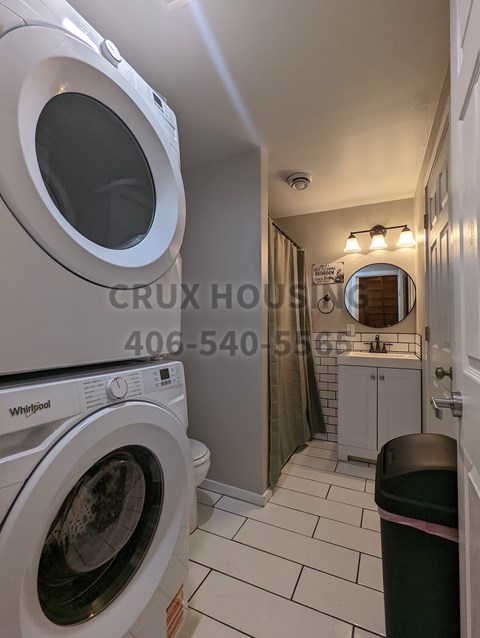 A small laundry room with a washer and dryer.