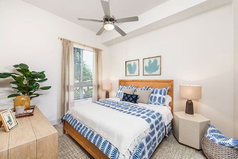 a bedroom with a bed and a ceiling fan