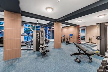 A gym with a variety of equipment including weights and cardio machines. at Morea Apartments, Pompano Beach, 33062