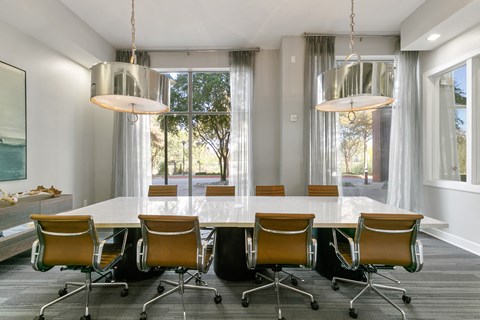 a conference room with a large marble table and chairs