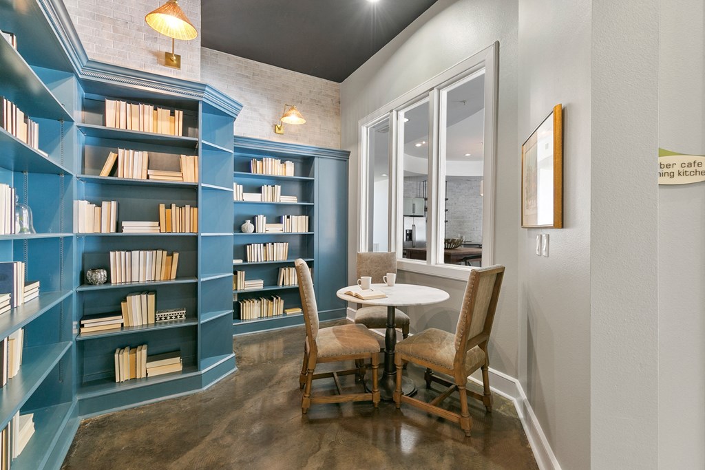 a dining room with a table and chairs and a blue book shelf