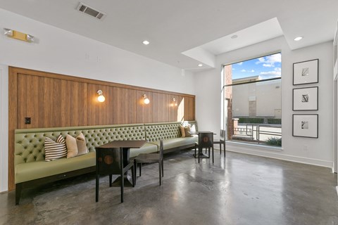 a living room with a couch and a table in front of a window