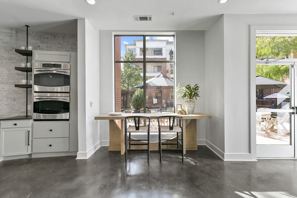 a kitchen with a table and chairs and a large window