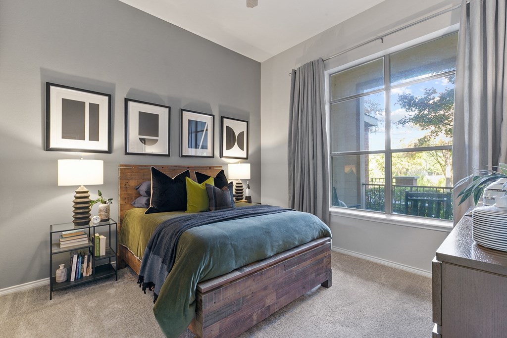 a bedroom with a bed and a large window