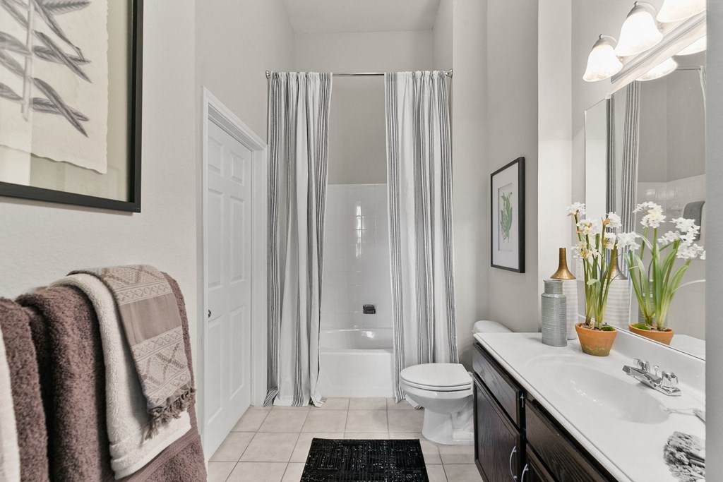 a bathroom with a shower and a toilet and a sink