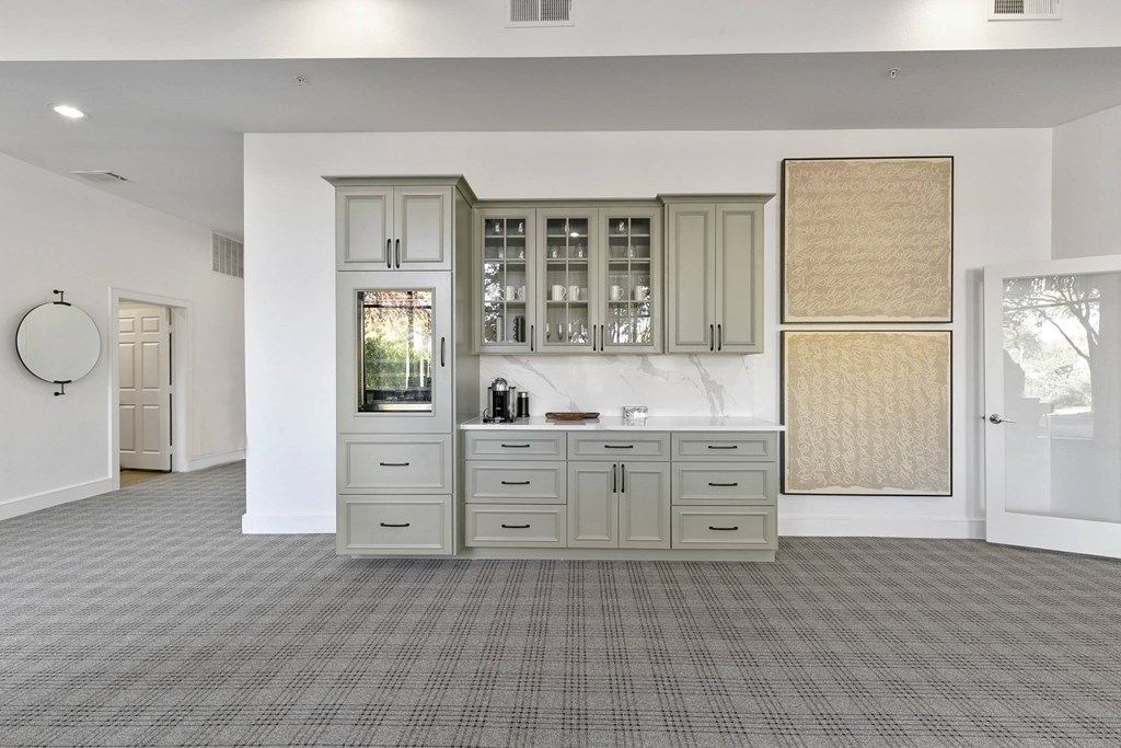 a large white kitchen with white cabinets and a counter top