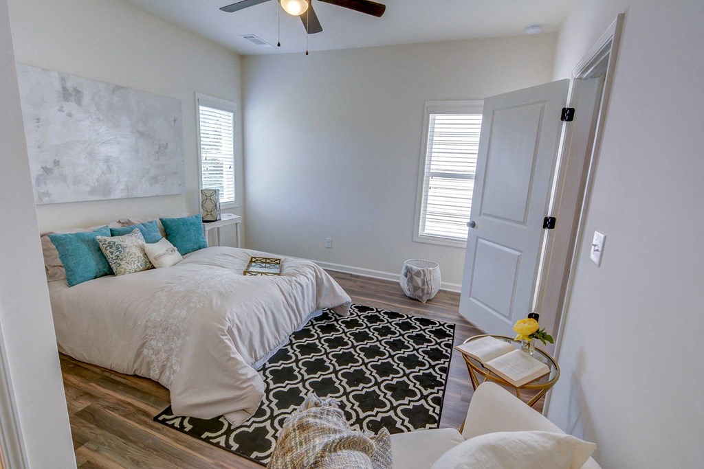 a bedroom with a bed and a ceiling fan