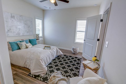 a bedroom with a bed and a ceiling fan