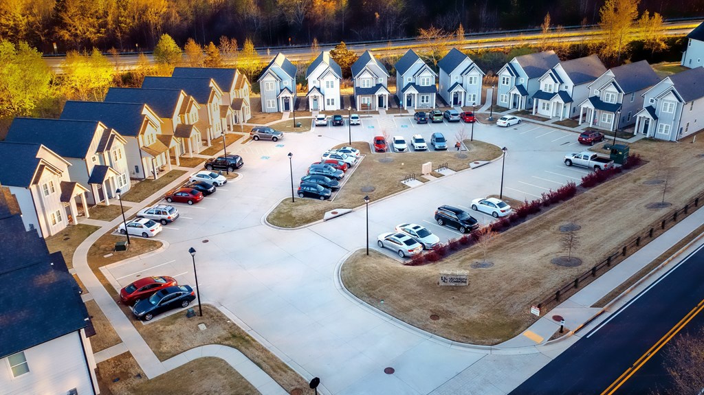 an aerial view of a neighborhood with rows of houses and cars parked in front of them