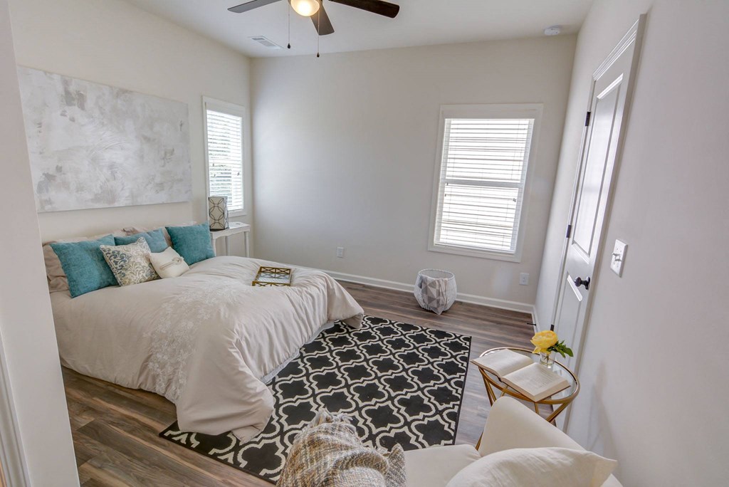 a bedroom with a bed and a ceiling fan