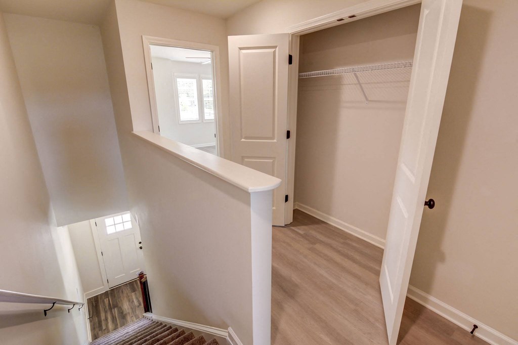 a bedroom with a medium sized bed and a closet with a mirrored door