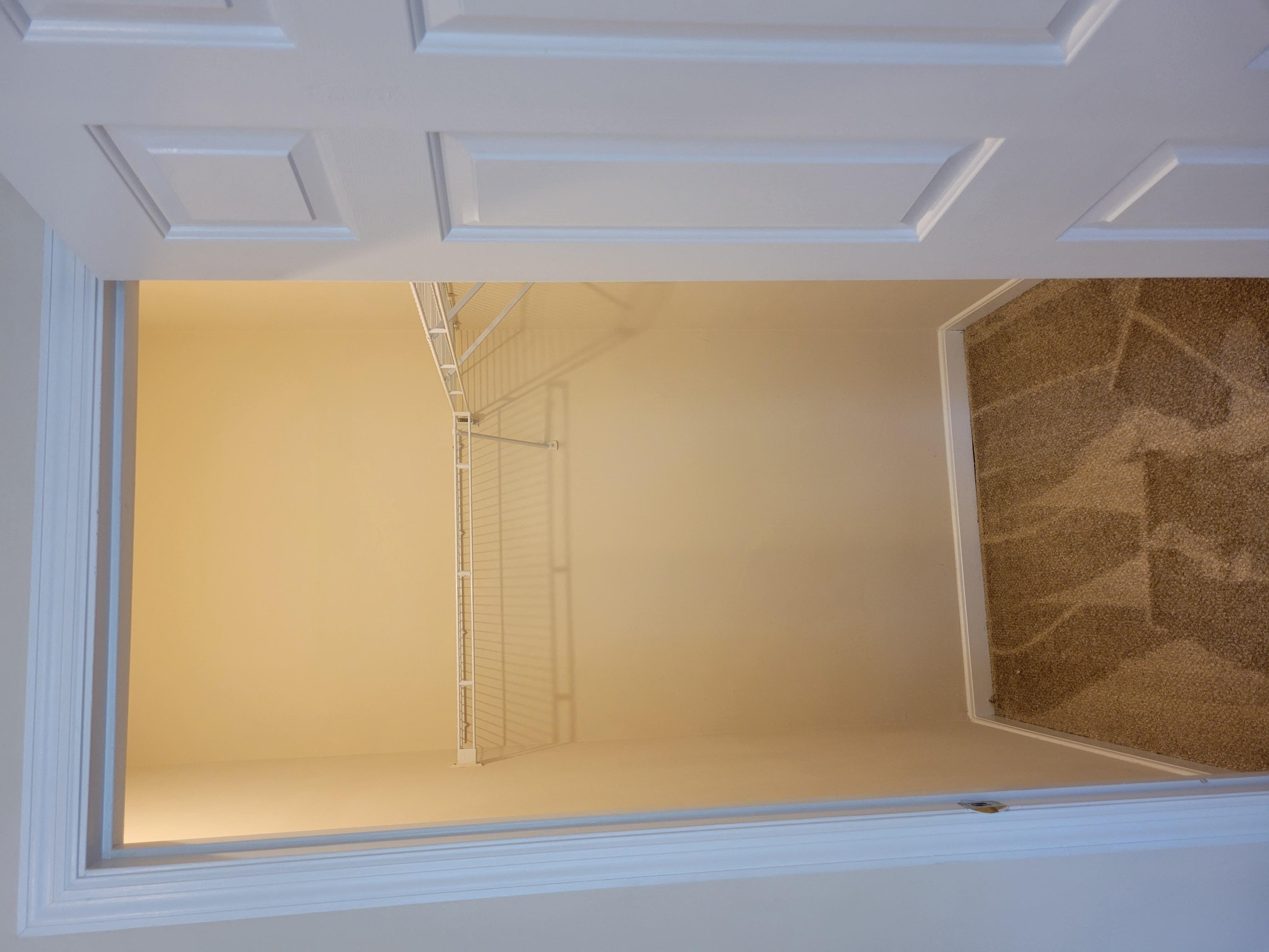 A white door with a window in the middle.