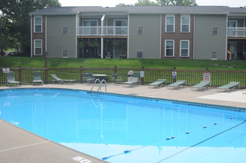 A pool in front of apartment buildings.