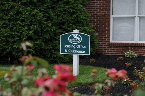 A sign for a leasing office and clubhouse is in front of a building at The Legends at Steeplechase Apartments, Richwood, Kentucky