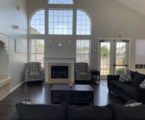 A living room with a fireplace and two chairs.
