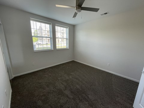 A room with a ceiling fan and carpeted floor at Hamlet On The Bend, Hebrun, KY, 41048