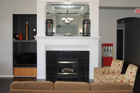A living room with a fireplace and a chair.