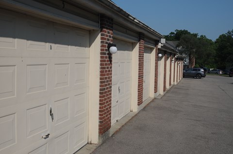 A row of white garage doors are closed.
