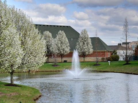 A fountain in the middle of a pond surrounded by trees. at Twin Fountains Apartments, Ohio, 45040
